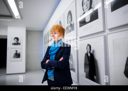 Photographer Herlinde Koelbl poses in front of photographs from her series 'Spuren der Macht' (lit. Traces of power) in the Ludwig Galerie Schloss Oberhausen in Oberhausen, Germany, 22 January 2015. The exhibition (25 January 2015 to 3 March 2015) entitled 'Das deutsche Wohnzimmer, Spuren der Macht, Haare und andere menschliche Dinge - Fotografien von 1980 bis heute' (lit. The German living room, traces of power, hair, and other human things - Photographs from 1980 to today' brings together works from the German artist's important artistic phases. Photo: RALF VENNENBERND/dpa Stock Photo