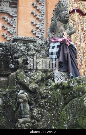 Decorative stone statues guarding the kori agung gate at Pura Taman Saraswati Ubud, Bali. Stock Photo