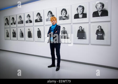Photographer Herlinde Koelbl poses in front of photographs from her series 'Spuren der Macht' (lit. Traces of power) that show Angela Merkel in the Ludwig Galerie Schloss Oberhausen in Oberhausen, Germany, 22 January 2015. The exhibition (25 January 2015 to 3 March 2015) entitled 'Das deutsche Wohnzimmer, Spuren der Macht, Haare und andere menschliche Dinge - Fotografien von 1980 bis heute' (lit. The German living room, traces of power, hair, and other human things - Photographs from 1980 to today' brings together works from the German artist's important artistic phases. Photo: RALF VENNENBERN Stock Photo