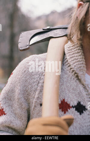 Close up of a man carrying an axe on his shoulder. Stock Photo