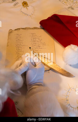 Santa Claus working on Gift List Stock Photo