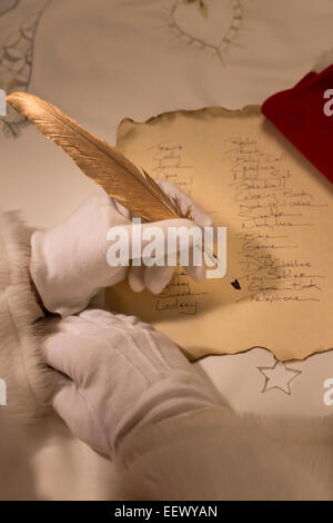 Santa Claus working on Gift List Stock Photo