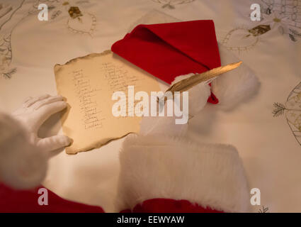 Santa Claus working on Gift List Stock Photo