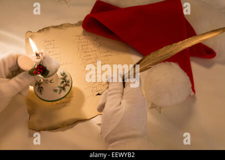 Santa Claus working on Gift List Stock Photo