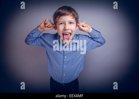 boy teenager European appearance brown grimaces experiencing joy Stock Photo