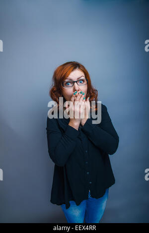 European - looking  woman years  hands  over his mouth Stock Photo