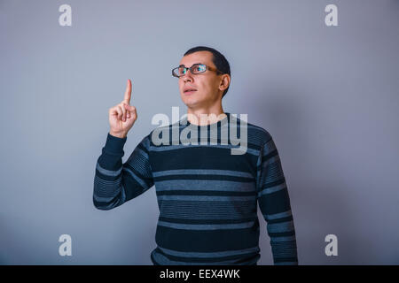 European-looking man of 30 years teacher glasses idea on a gray Stock Photo