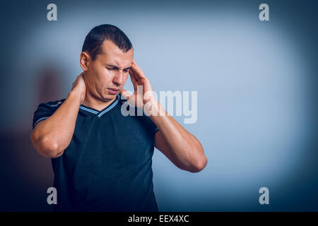 European-looking man holding his hands behind head Stock Photo