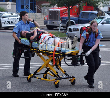 CT USA  EMS workers help a 'victim' during a mock casualty drill at Seymour High School. The drill which included Emergency workers from all over the Valley and Bethany prepared the first responders to a large crisis situation. The drill had a multiple gunmen, a large explosion and fire with multiple casualties to which the responders had to deal with. Stock Photo
