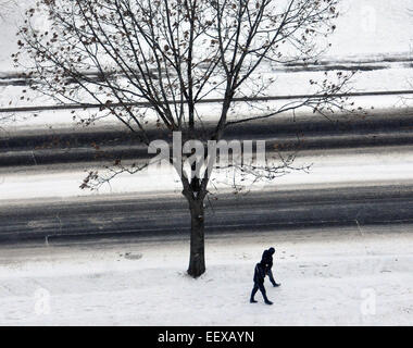 People walk  along Eastern Street in New Haven during Saturday's snowstorm. Stock Photo