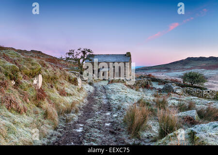 A beautiful frosty winter's morning on Bodmin Moor with an old abandoned cottage and Brown Willy, the highest point in Cornwall Stock Photo