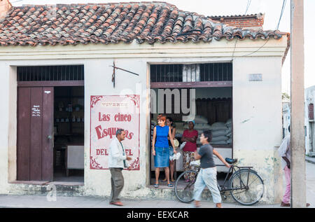 Local people in the street in front of a shop and in the shop, in Camaguey, Cuba's third largest city Stock Photo
