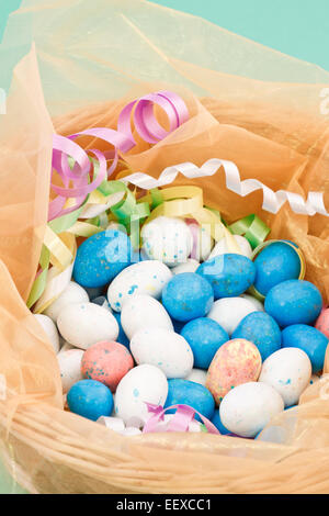 easter basket filled with colorful eggs and decorations Stock Photo