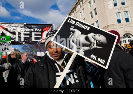 Washington DC, USA. 22nd Jan, 2015. Pro-Life supporters march carrying signs toward the Supreme Court building. Credit:  B Christopher/Alamy Live News Stock Photo