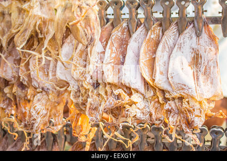 Dried squid on the peg of the trolley. Stock Photo