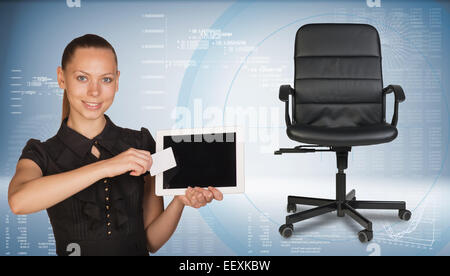 Businesswoman holding tablet PC and business card. Office chair beside Stock Photo