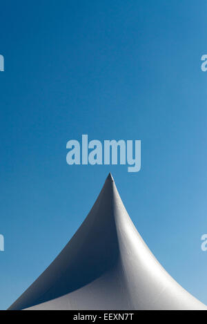 White tent for events with spier and blue sky Stock Photo