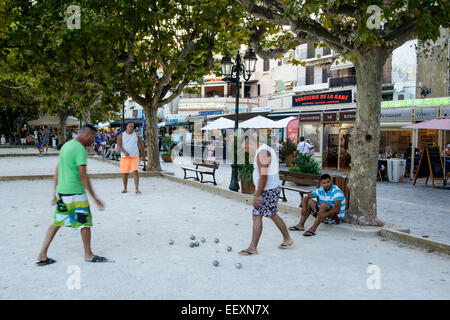 A group of people playing the ball game (la pétanque) in summer evening in Le Lavandou, Var, PACA, France Stock Photo