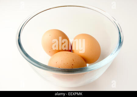 Three Brown Free Range Eggs in a Glass Bowl Stock Photo
