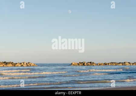 An incredible moon rise over the sea in Italy Stock Photo