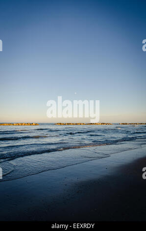An incredible moon rise over the sea in Italy Stock Photo