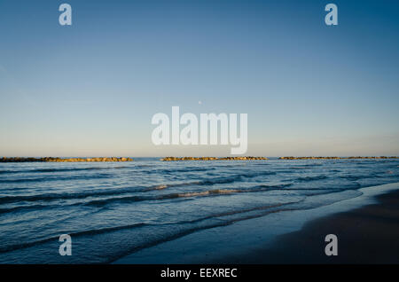 An incredible moon rise over the sea in Italy Stock Photo