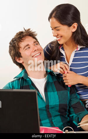 Two students in a classroom with a laptop Stock Photo