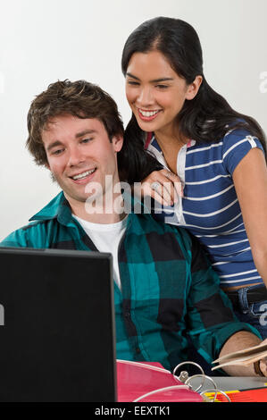 Two students in a classroom with a laptop Stock Photo