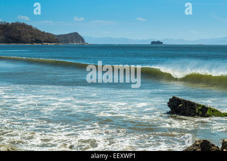 Surf wave at beautiful Playa El Coco beach south of San Juan del Sur; Playa El Coco, San Juan del Sur, Rivas Province, Nicaragua Stock Photo