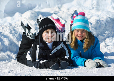 Brother and sister playing outdoors in winter Stock Photo