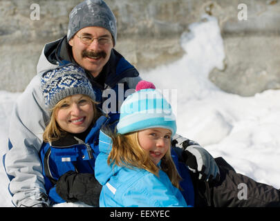 Family posing outdoors in winter Stock Photo