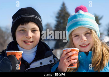 Brother and sister outdoors in winter Stock Photo