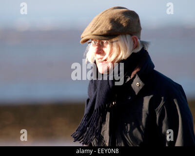 Mature woman wearing a flat cap, UK Stock Photo