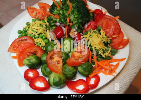 appetizing vegetarian plate full sappy vegetables pepper, broccoli, peas, tomato, Brussels sprouts, haricot, onion, Stock Photo