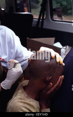 MSF nurse tends to Rwandan Tutsi woman lying injured in Burundi 1994 ...