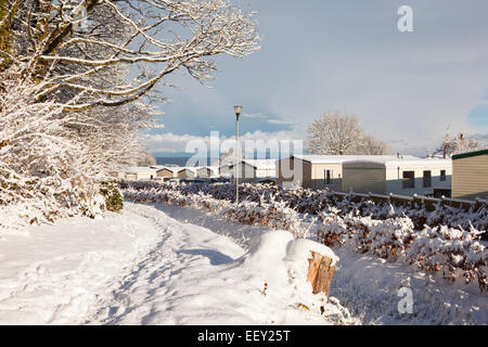 Snow on ground along Isle of Anglesey Coast Path beside a campsite in Red Wharf Bay, Isle of Anglesey, North Wales, UK Stock Photo