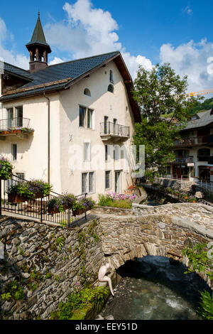 Old stone bridge and statue in the ski resort of Megeve, Haute-Savoie, French Alps, France, Europe Stock Photo