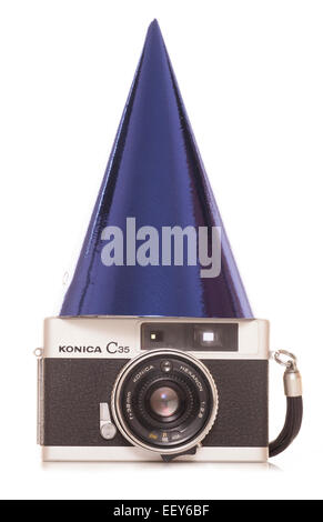 vintage slr film camera with party hat cutout Stock Photo