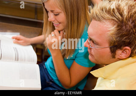 Young man and woman in a library Stock Photo