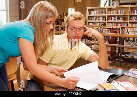 Young man and woman in a library Stock Photo