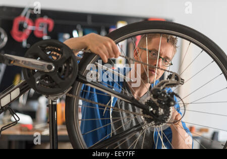 Man repairing bike in shop Stock Photo