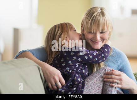 Daughter (4-5) telling secret to mother Stock Photo