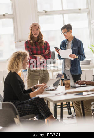 Friends working in office Stock Photo