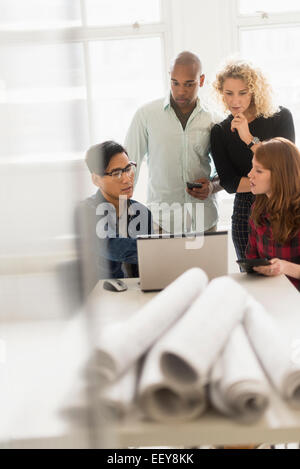 Friends working on project in office Stock Photo