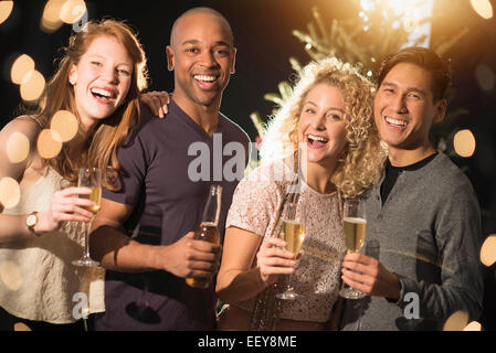 Cheerful friends celebrating New Year's Eve Stock Photo