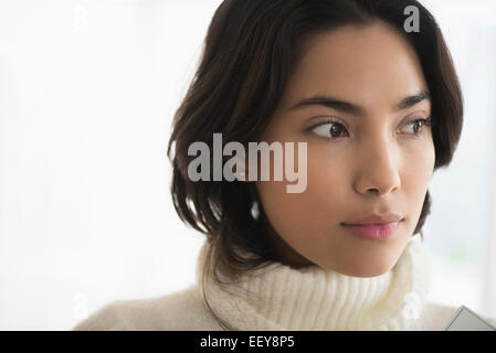 Serious brunette woman looking away Stock Photo