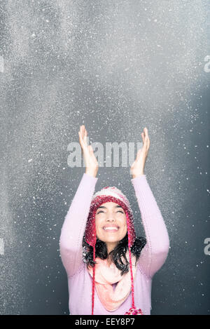 Happy Young Woman Wearing Sweater And Hat Isolated Over Blue Background 