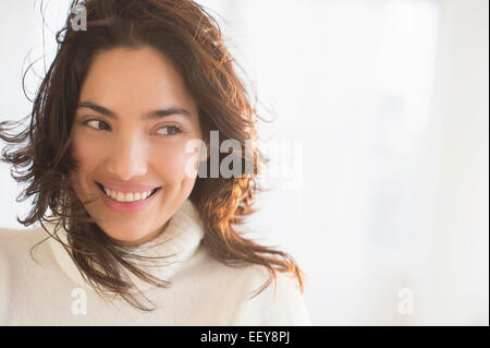 Smiling young woman looking sideways Stock Photo