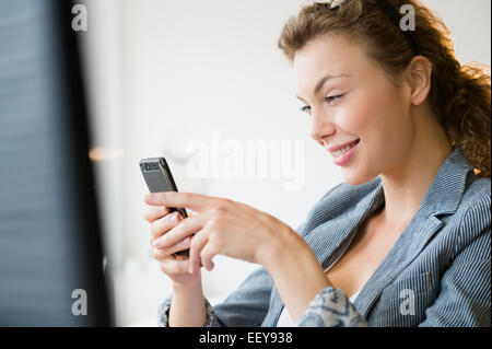 Young businesswoman using mobile phone Stock Photo