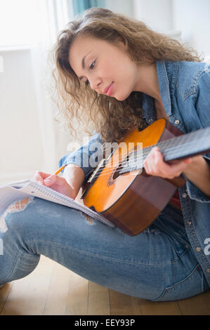 Young woman playing guitar Stock Photo